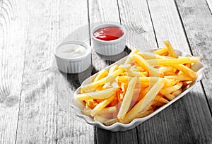 Crispy Potato Fries on Plate with Dipping Sauce photo
