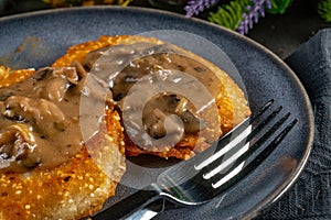 Crispy potato pancakes with mushroom sauce