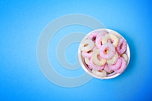 Crispy rice healthy baby wheels closeup in white dose against blue background