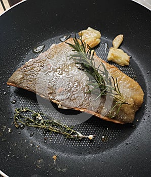 Crispy skin pan fried salmon with herb rosemary garlic and thyme