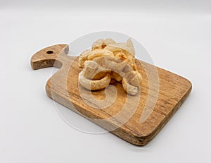 Crispy skin pork on wooden chopping board isolated on white