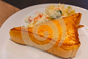 Crispy and tasty yellow bread french toast with mashed potato on white ceramic plate. Delicous fast meal for family. Yummy but unh