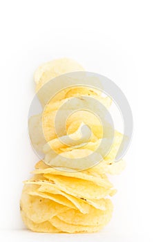 Crispy thinly sliced potato chips, on white.