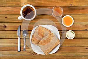 Crispy toast with butter, apple jelly and hot tea for breakfast