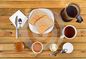 Crispy toast with butter, apple jelly and hot tea for breakfast