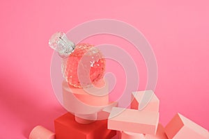 cristal glass perfume bottle on pink background copy space