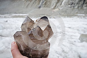 Cristalllier holding smoky quartz crystals