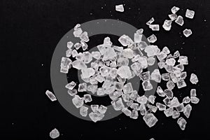 Cristals of sea salt on black background photo