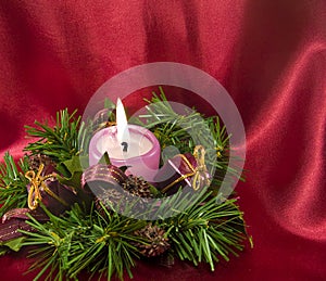 Cristmas decoration with a candle on red