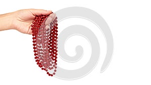 Cristmas decoration, ceramic red ball chain in hand isolated on white background. New Year object, Mardi Gras beads. copy space, t