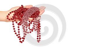 Cristmas decoration, ceramic red ball chain in hand isolated on white background. New Year object, Mardi Gras beads. copy space, t
