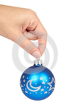 Cristmas decoration, glass blue ball in hand isolated on white background. New Year object