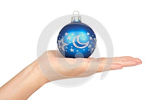 Cristmas decoration, glass blue ball in hand isolated on white background. New Year object