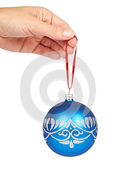 Cristmas decoration, glass blue ball in hand isolated on white background. New Year object