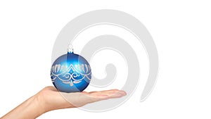 Cristmas decoration, glass blue ball in hand isolated on white background. New Year object. copy space, template