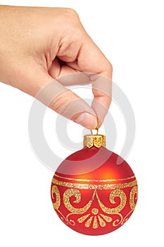 Cristmas decoration, glass red ball in hand isolated on white background. New Year object