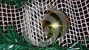 Cristmas ball decoration on a meshy curtain with fir twigs photo