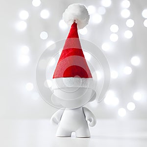 Cristmas toy in Red Hat Santa Claus, Symbol New Year, Defocused Lights White Background