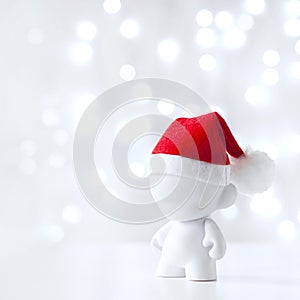 Cristmas toy in Red Hat Santa Claus, Symbol New Year, Defocused Lights White Background