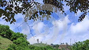 Cristo Rei (Christ the King) statue of Dili under cloudy and blue sky in Timor-Leste photo