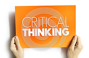 Critical thinking - analysis of facts to form a judgment, text on card concept background