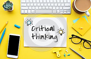 Critical thinking concepts with text on worktable