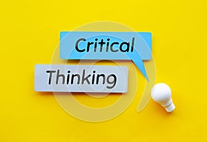 Critical thinking Idea and creativity concepts with lightbulb and speech bubbles paper on yellow