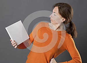 Critical woman with hand on hips judging an questioning information photo