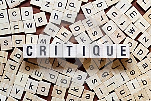 Critique word concept on cubes photo