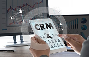 CRM Business Customer CRM Management Analysis Service Concept Business team hands at work with financial reports and a laptop