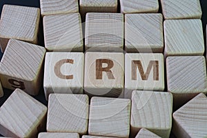 CRM, Customer Relationship Management, loyalty program, repeat purchase frequency concept, cube wooden block with alphabet combine