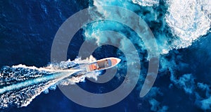 Croatia. Aerial view of luxury floating boat on blue Adriatic sea at sunny day. Fast boat on the sea surface. Seascape from drone.