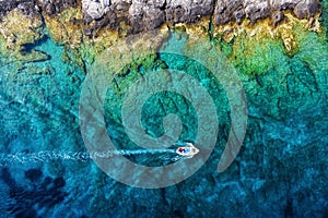 Croatia. Boat at the sea surface. Aerial view of  floating boat on blue Adriatic sea at sunny day.