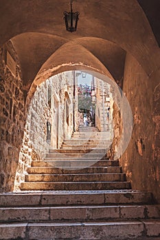 Croatia.Dubrovnik.The staircase goes upstairs.Sunlight shines through the arch.