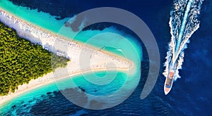 Croatia, Hvar island, Bol. Aerial view at the Zlatni Rat. Aerial view of luxury floating boat on blue Adriatic sea at sunny day.