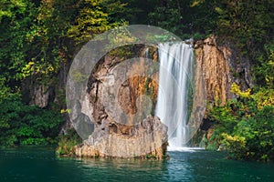 Croatia. Plitvice Lakes. Waterfall surrounded by cliffs and autumn trees