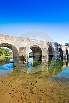 Croatia, river Dobra and old stone bridge in Novigrad