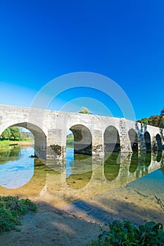 Croatia, river Dobra and old stone bridge in Novigrad