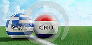 Croatia vs. Greece Soccer Match - Soccer balls in Croatia and Greece national colors on a soccer field.