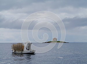 A Croatian fishing vessel and the Mulo lighthouse