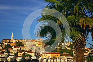 Croatian harbour in front of a village on a hill