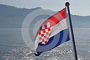 Croatian national flag flying at windy day