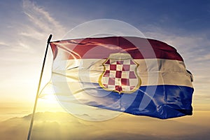 Croatian Republic of Herzeg-Bosnia flag textile cloth fabric waving on the top sunrise mist fog