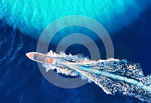 Croatian seascape with boat. Yachts at the sea surface. Aerial view of luxury floating boat on blue Adriatic sea at sunny day.
