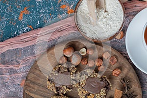 Crocante chocolate cookies with nuts on a wooden board