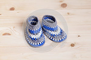 Crochet Baby Booties on wooden background