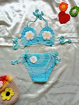 Crochet bikini handmade for baby girl background texture