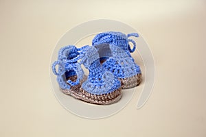 Crochet Blue Baby Booties on gray background
