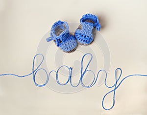 Crochet Blue Baby Booties on gray background