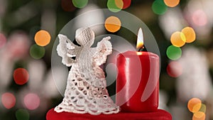 Crochet christmas angel decoration and burning candle spinning